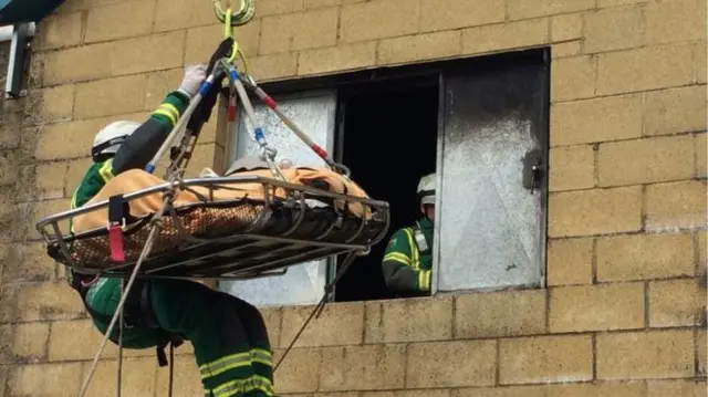 Fireman rescuing an obese person