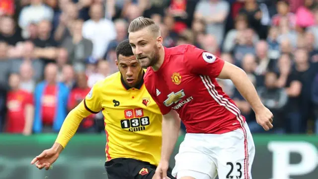 Etienne Capoue and Luke Shaw challenge for the ball