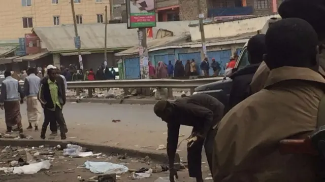 A hawker picking up his produce in Eastleigh, Nairobi, Kenya