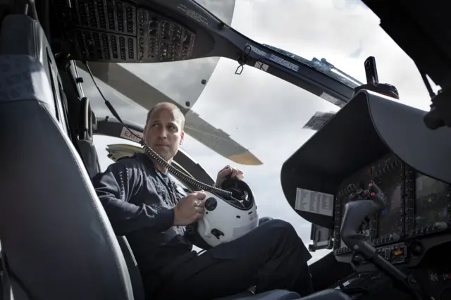 The Duke of Cambridge, in flying uniform, in the cockpit of an H145 helicopter