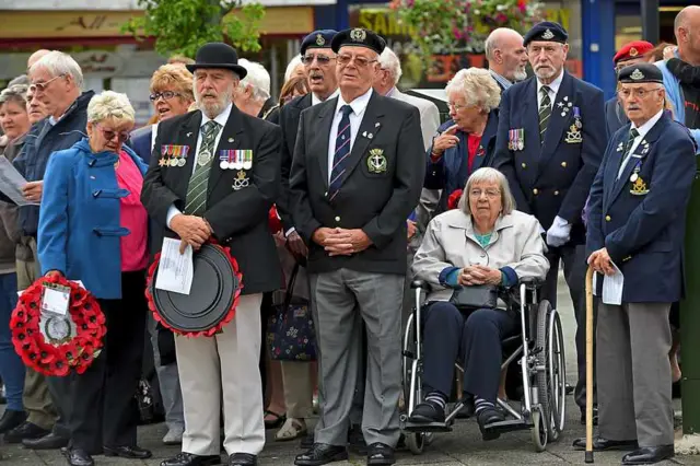 People paying respect at memorial