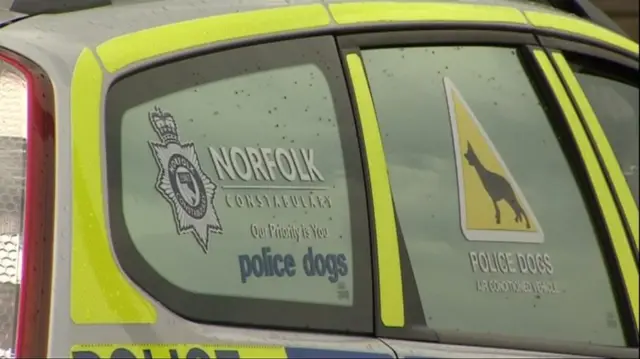 Police vehicle, with sign on window for police dogs