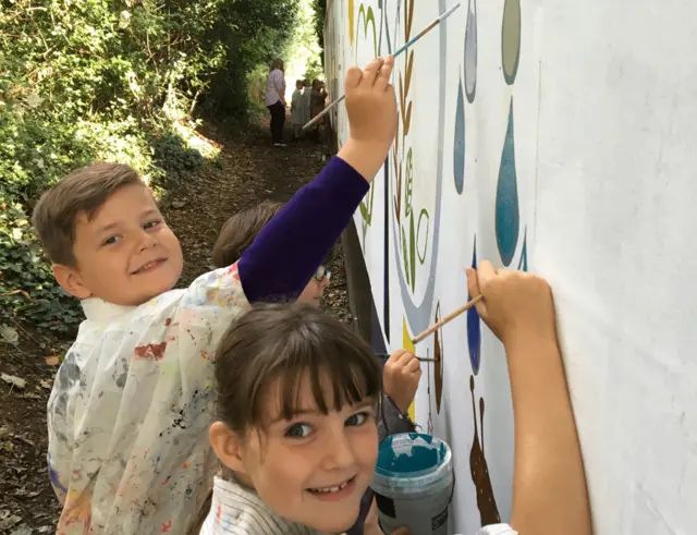 Woodbridge Primary School pupils painting mural