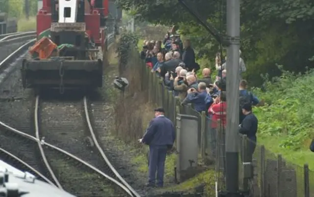 Crowds beside a railway line