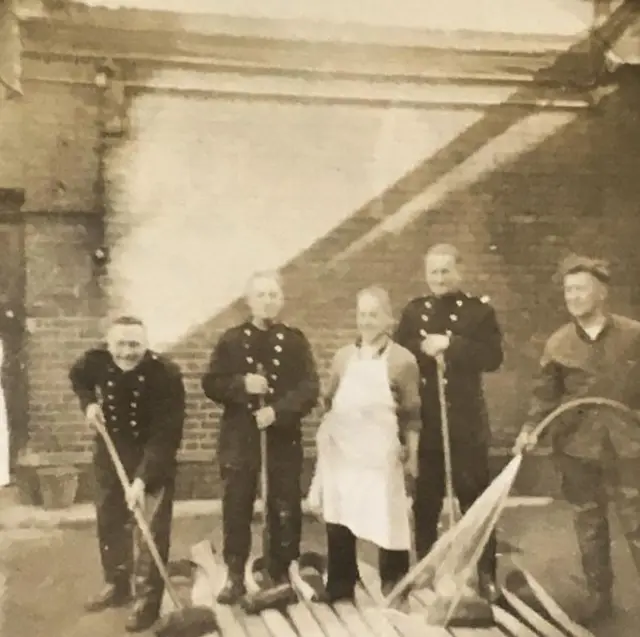 Firefighters cleaning up in 1956