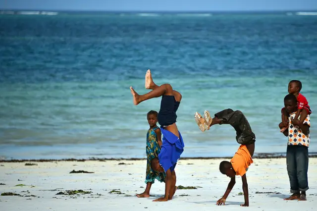 Children on a beach in Tanzania