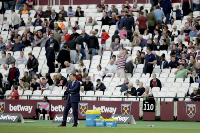 West Ham fans leave as their manager Slaven Bilic stands with his arms folded