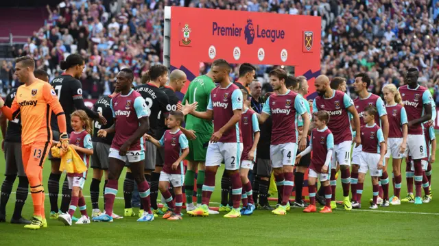 Players and officials shake hands