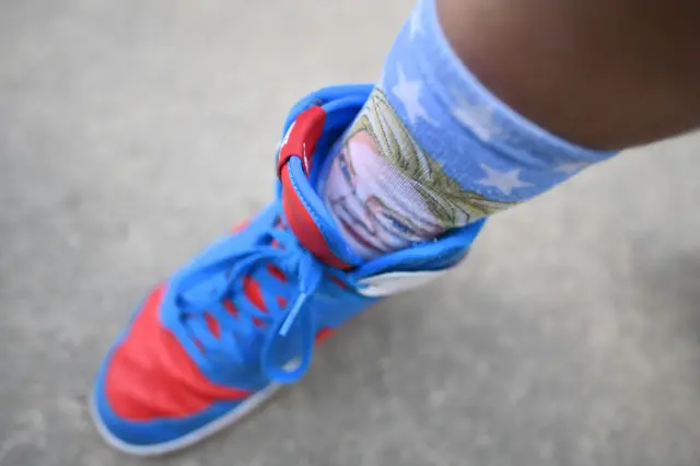 A Clinton supporter displays his "Hillary" socks at Hofstra University.