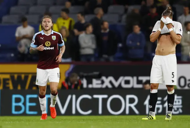 Burnley"s Jeff Hendrick celebrates scoring their first goal as Watford"s Sebastian Prodl looks dejected