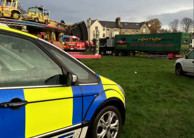 Police car in front of funfair