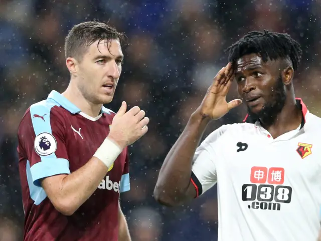 Burnley"s Stephen Ward after a collision with Watford"s Isaac Success