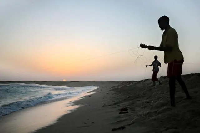 Somali boys drawing their fishing lines at the coastal town of Hobyo in north-eastern Somalia - 2010