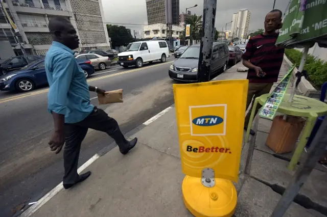 A man walks past a MTN notice board in Lagos, on October 27, 2015
