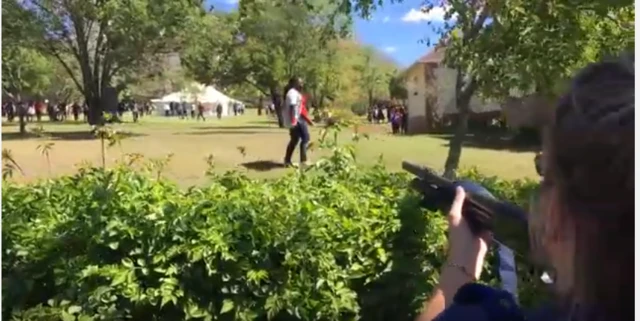 .Undeterred one of the students walks casually across the line of fire