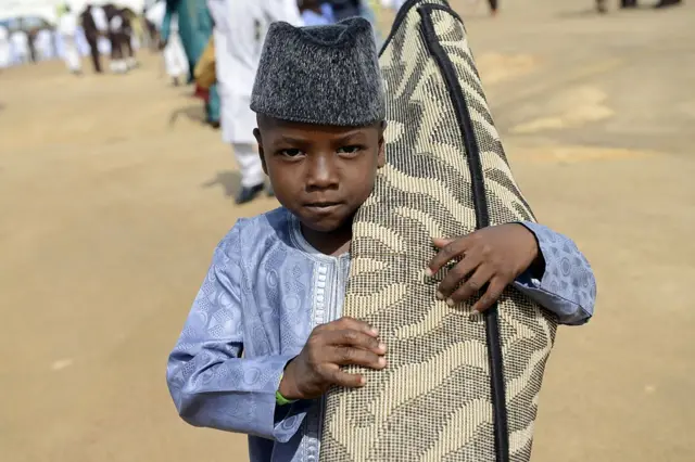 Boy carrying a mat