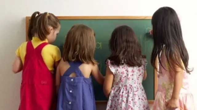 Children writing on blackboard