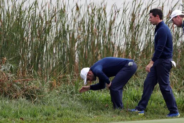 Sullivan and McIlroy search for their ball