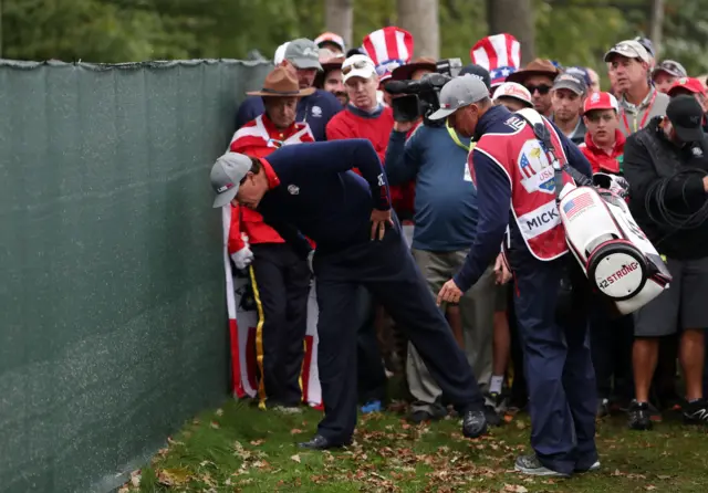 Phil Mickelson inspects his ball