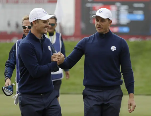 Justin Rose and Henrik Stenson celebrate winning the ninth hole