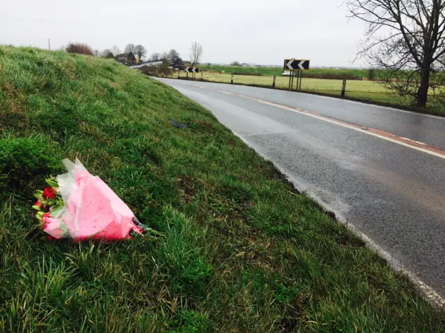 Flowers lay at the side of the road