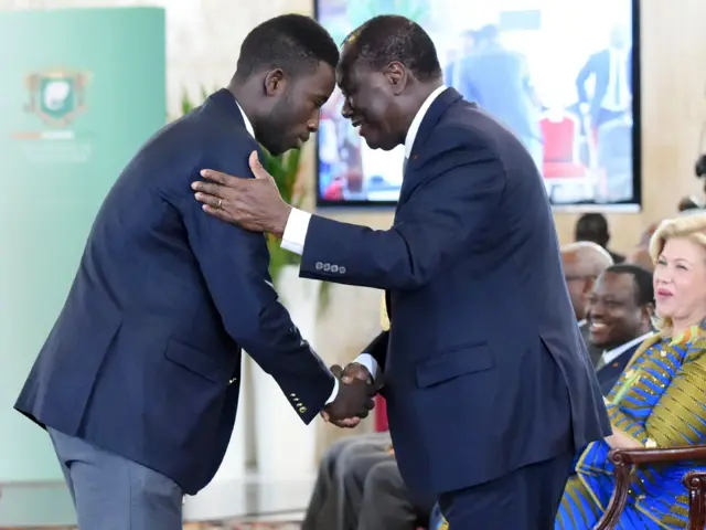 Ivory Coast's 2016 Olympic games gold medalist in taekwondo Cheick Sallah Cisse Ivorian President Alassane Ouattara September 5, 2016 during a ceremony at the Presidential Palace in Abidjan