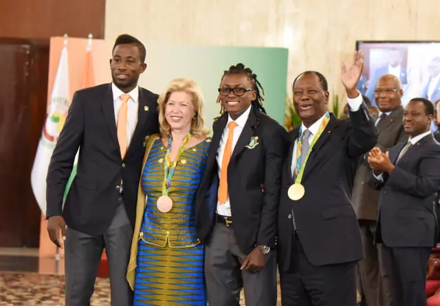 Ivory Coast"s 2016 Olympic games gold medalist in taekwondo Cheick Sallah Cissed (L) and Ivory Coast's 2016 Olympic games bronze medalist in taekwondo Ruth Marie Chistelle Gbagbi (C) pose with Ivorian President Alassane Ouattara (R) and his wife Dominique Ouattara (2ndL) on September 5, 2016 during a ceremony at the Presidential Palace in Abidjan.