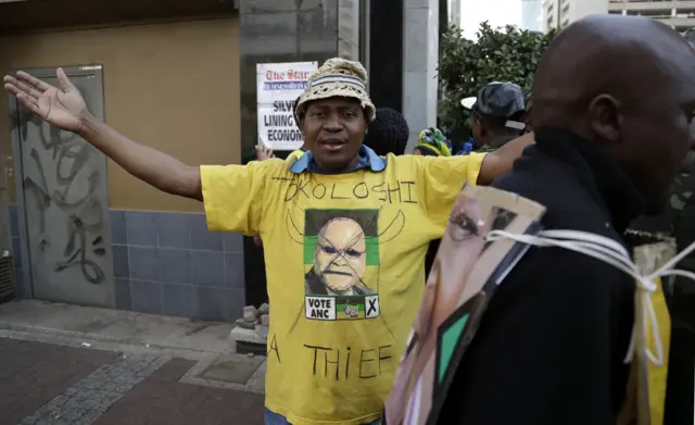 A supporter of the African National Congress, wearing a defaced t-shirt with president Jacob Zuma during their protest outside the ruling party ANC headquarters in downtown Johannesburg, South Africa,