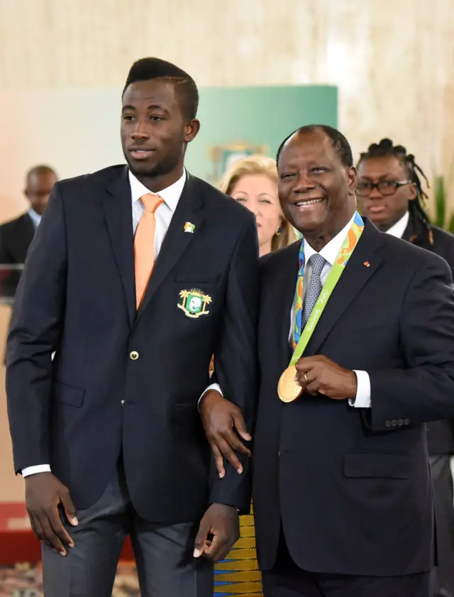 Ivory Coast's 2016 Olympic games gold medalist in taekwondo Cheick Sallah Cisse Ivorian President Alassane Ouattara September 5, 2016 during a ceremony at the Presidential Palace in Abidjan