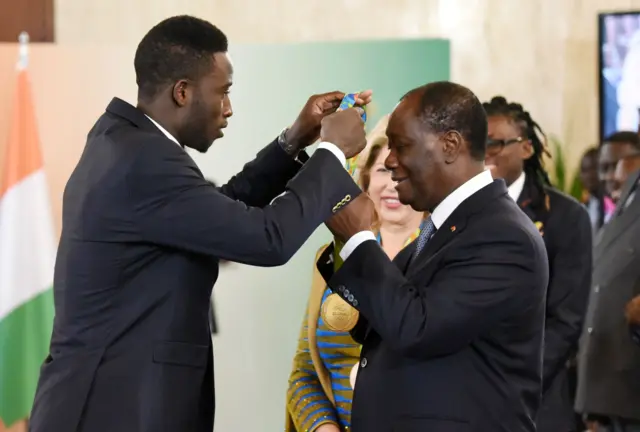 Ivory Coast's 2016 Olympic games gold medalist in taekwondo Cheick Sallah Cisse Ivorian President Alassane Ouattara September 5, 2016 during a ceremony at the Presidential Palace in Abidjan