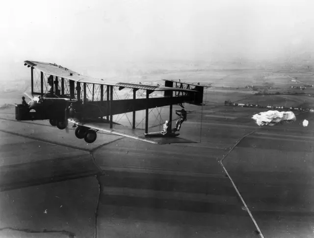 RAF pilots practising parachute jumps over Henlow in Bedfordshire from the wing of a Vickers Virginia Mk X, nicknamed 'Ginny'.