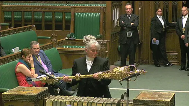 One of the Associate Serjeant at Arms removes the ceremonial mace, to signify the House is in committee