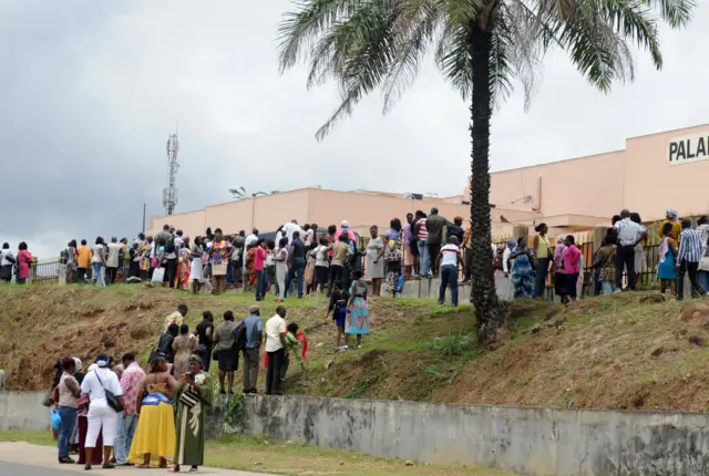 crowds wait outside the law courts in libreville