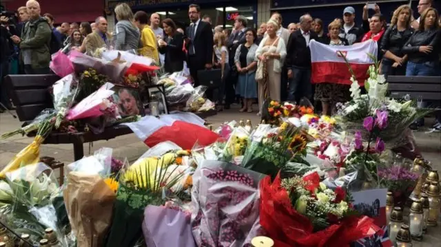 Flowers laid at vigil for Arkadiusz Jozwik