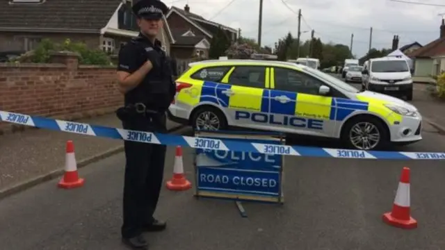 Police outside the cordoned-off bungalow