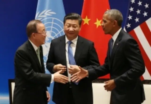 President Barack Obama, right, and UN Secretary-General Ban Ki-moon shake hands in front of Chinese President Xi Jinping during a joint ratification of the Paris climate change agreement