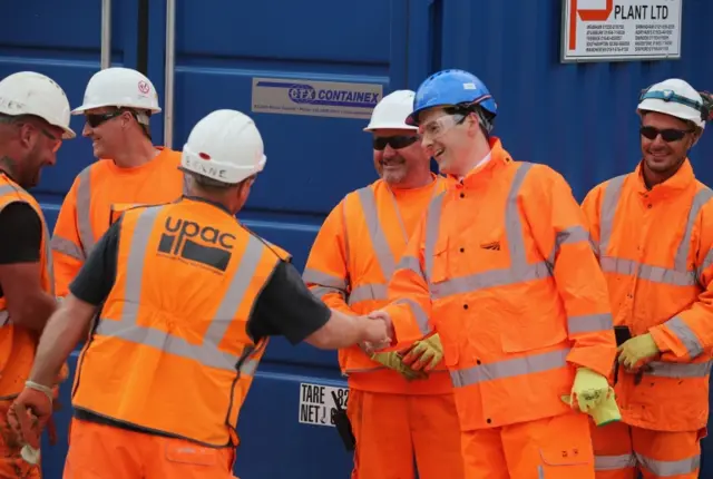 Former Chancellor of the Exchequer George Osborne chats to workers during a visit to Farnworth Tunnel electrification works in Bolton, in May last year