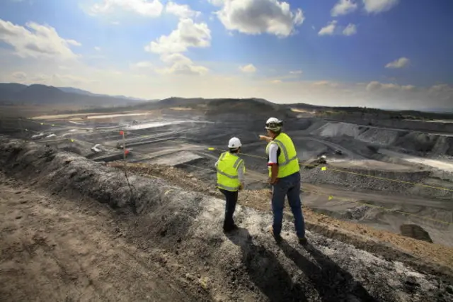 Workers viewing a large modern open-cut and shaft mine system in the upper Hunter Valley