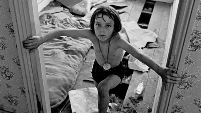 A young boy playing in a run-down house in Balsall Heath in 1970