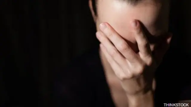 Teenager with head in her hands