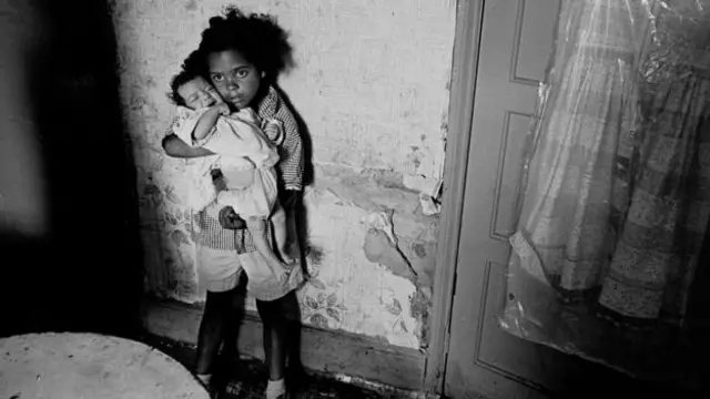 A young girl holds her baby sister in Balsall Heath, Birmingham in 1970