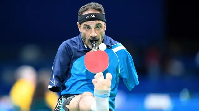 Ibrahim Hamadtou playing table tennis with his mouth