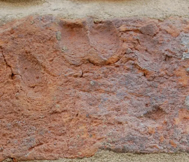 A medieval brickmaker’s signature, his handprint, preserved in the wall.