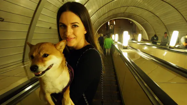 A woman holding her dog