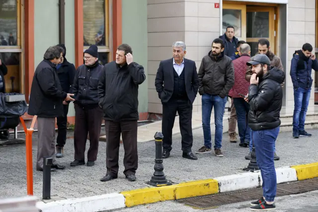 Relatives of victims from the Reina nightclub, which was attacked by a gunman, wait outside the forensic medicine institute in Istanbul