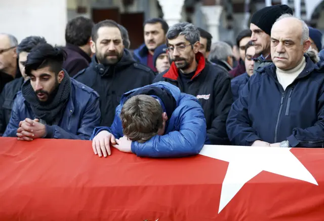 Relatives react at the funeral of Ayhan Arik, a victim of an attack by a gunman at Reina nig