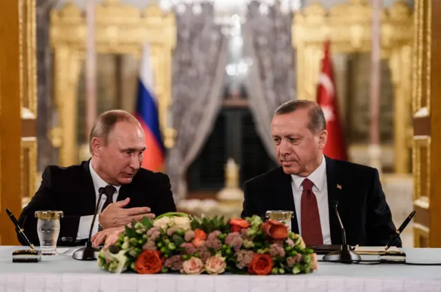 This file photo taken on October 10, 2016 shows Russian President Vladimir Putin (L) speaking to Turkish President Recep Tayyip Erdogan (R) as they attend a press conference in Istanbul. October 2016