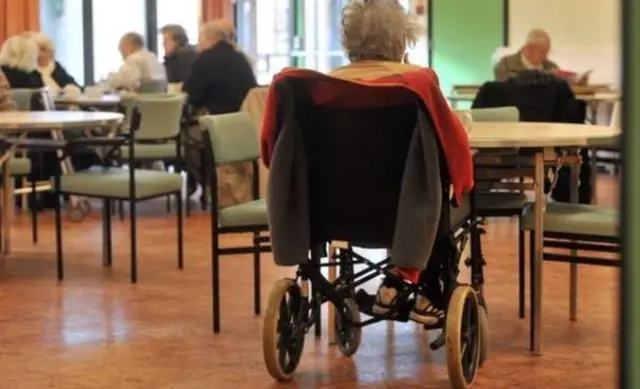 Woman sat in a wheelchair at a care home