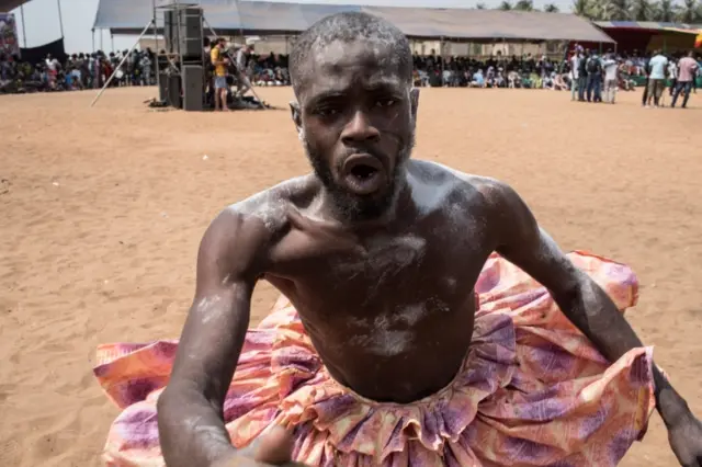 A Vodoo devotee dressed up in a costume performs at the annual Voodoo Festival on January 10, 2017 in Ouidah