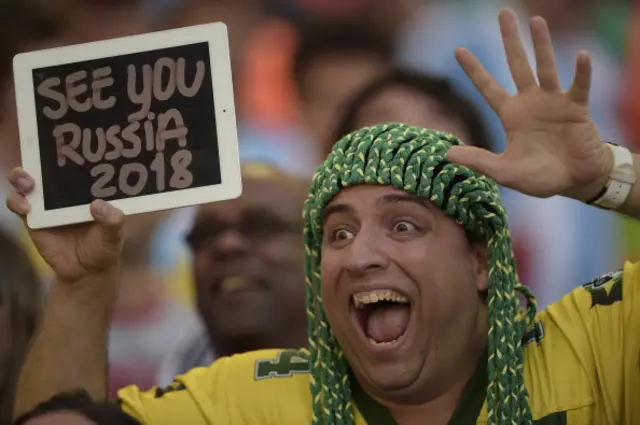 Collection: AFP Brazilian supporter gestures while displaying a pad reading 'See you Russia 2018' before start the 2014 FIFA World Cup Brazil final football match between Germany and Argentina at the Maracana Stadium in Rio de Janeiro on July 13, 201